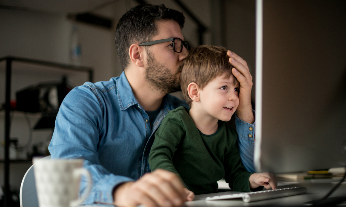 Parent and child looking at family photos on computer